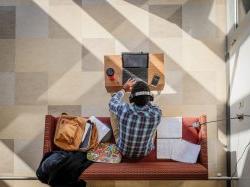 Student in CELS lounge using computer